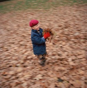 GB. London. Felix NAYLOR MARLOW's sixth birthday party. Felix in the autumn leaves. 2004.