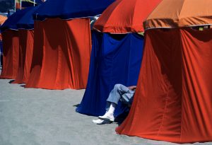 Dennis Stock. Individual changing tents on the beach. 1985.